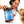 Woman holding a jar of Visionary Pet Foods Gourmet Chicken & Ghee Spread for Dogs with a dog licking her hand.