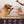 Dog reaching for a package of 'Smart Dogs Eat Low Care' freeze-dried medallions with a person holding the package.