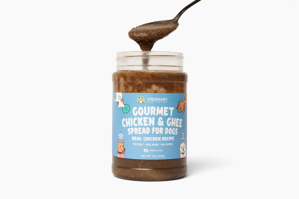 Jar of gourmet chicken and ghee spread for dogs with a spoonful of the product on a white background.